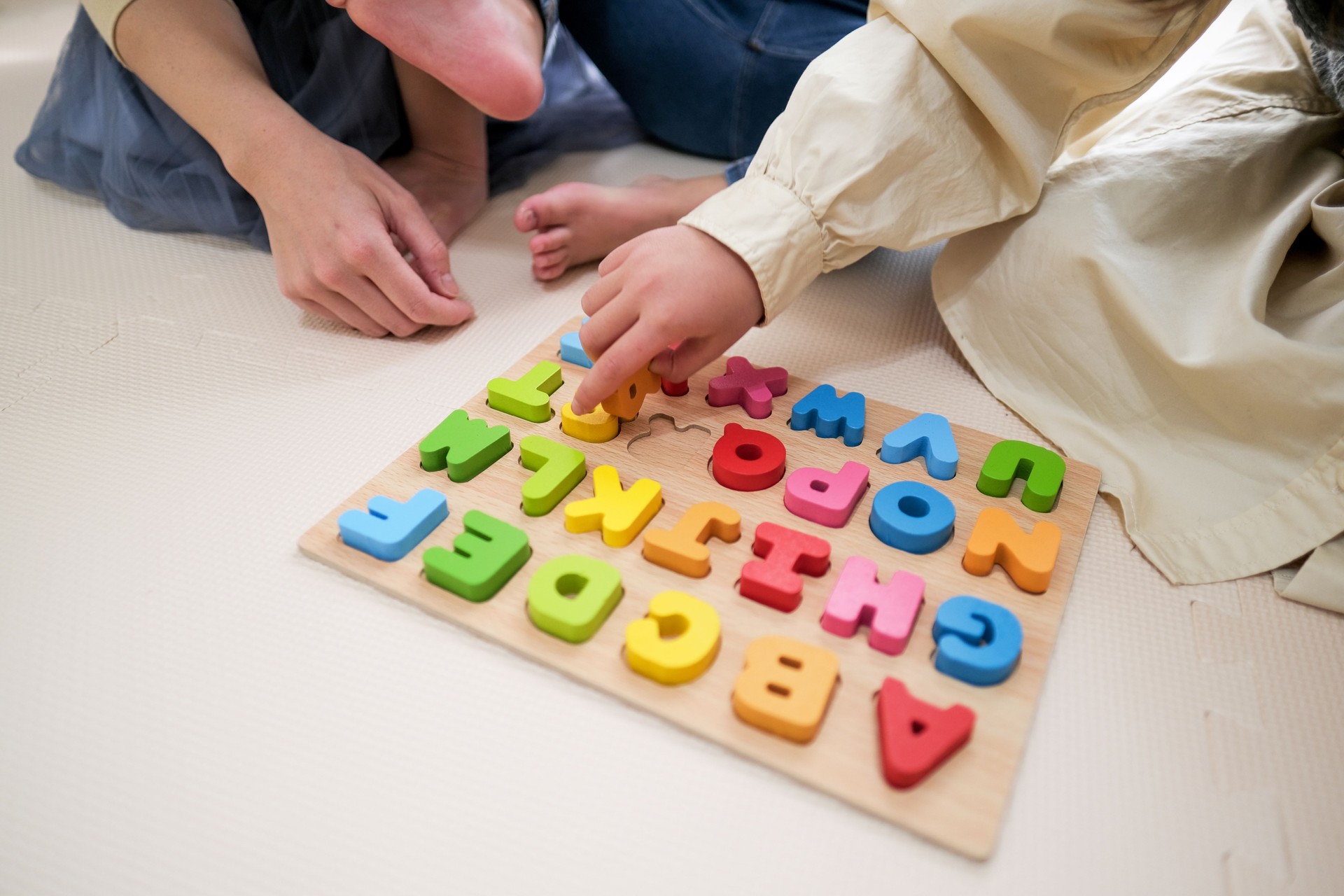 Closeup of Child's hands playing with alphabet-toy-block