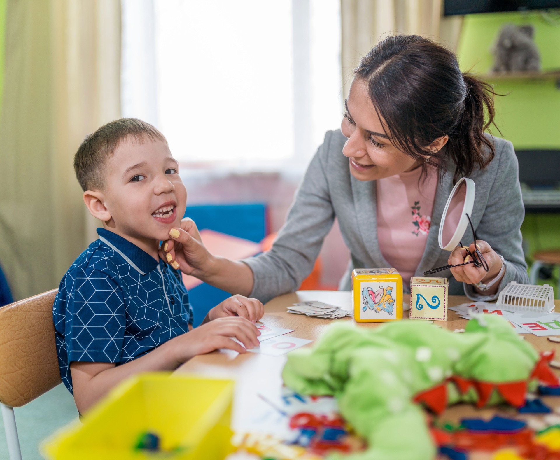 Woman Speech Therapist and Boy During Lesson to Correcting Pronunciation