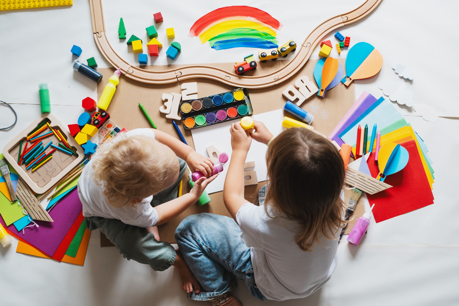 Children drawing and making crafts in kindergarten or daycare.